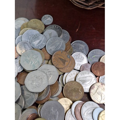 606 - A woven basket containing 9 kilograms worth of Irish coinage. unchecked