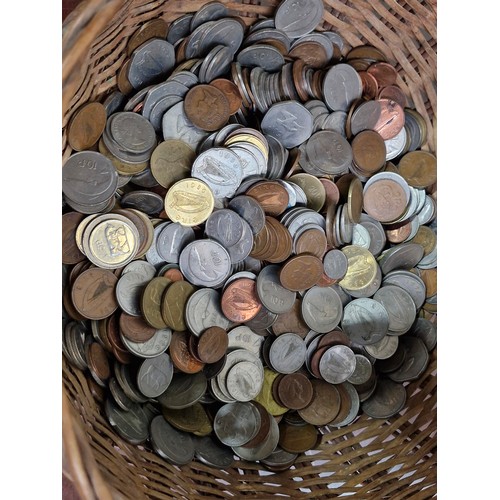 606 - A woven basket containing 9 kilograms worth of Irish coinage. unchecked