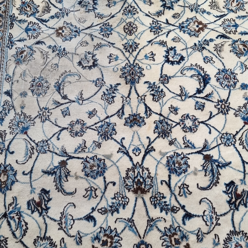 949 - Large Handwoven vintage Persian wool rug with blue floral design on cream background. Originally ret... 