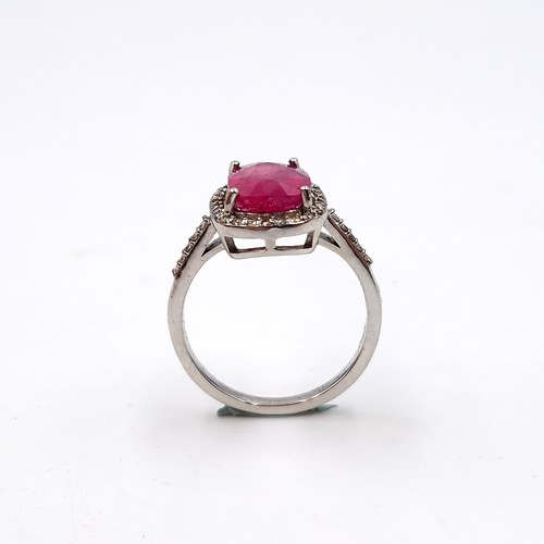 979 - Star Lot : A very fine example of a ruby stone ring with diamond set surround mounted in sterling si... 