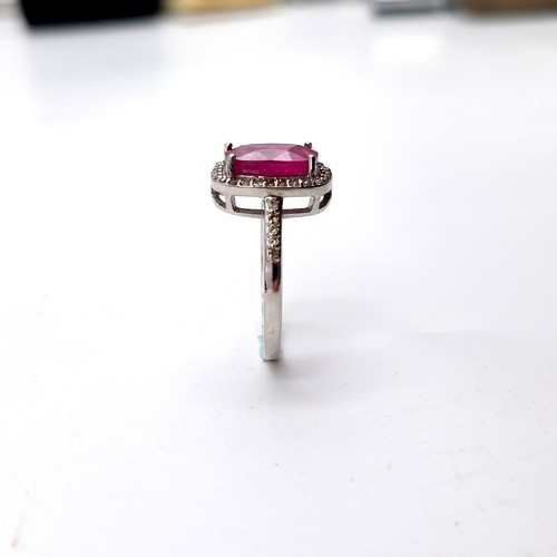 979 - Star Lot : A very fine example of a ruby stone ring with diamond set surround mounted in sterling si... 