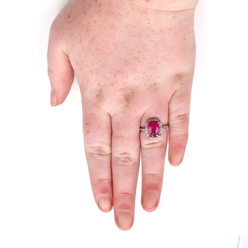 979 - Star Lot : A very fine example of a ruby stone ring with diamond set surround mounted in sterling si... 