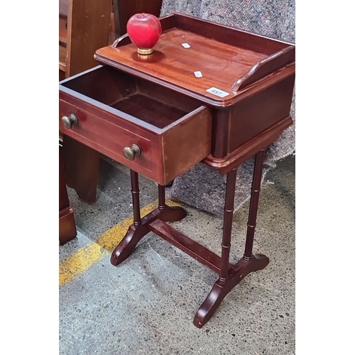 987 - A neat size Mahogany side table features one drawer with turned legs and brass drawer pulls and gall... 