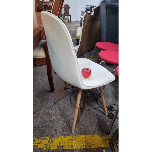 994 - White upholstered Eames style chair, wooden legs, 85 cm height. Features tufted stitching on seat an... 