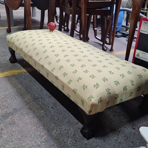 995 - A large Victorian upholstered low bench, circa late 19th century. Cream fabric with green floral mot... 