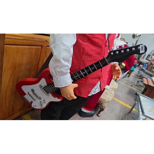 1001 - Life-size animated Santa Claus figure. It features a red sequin vest and a guitar, and stands approx... 