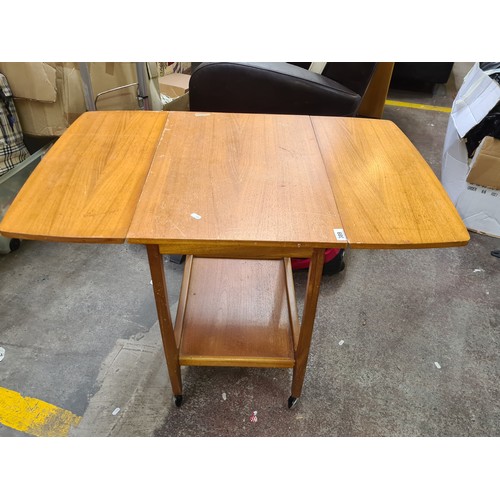 1005 - Star Lot : A fabulous teak mid century drop leaf hostess trolley with shelf beneath with lovely curv... 