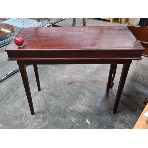 1086 - Mahogany console table, features tapered legs and clean lines. Measurements: 48 inches long, 18 inch... 