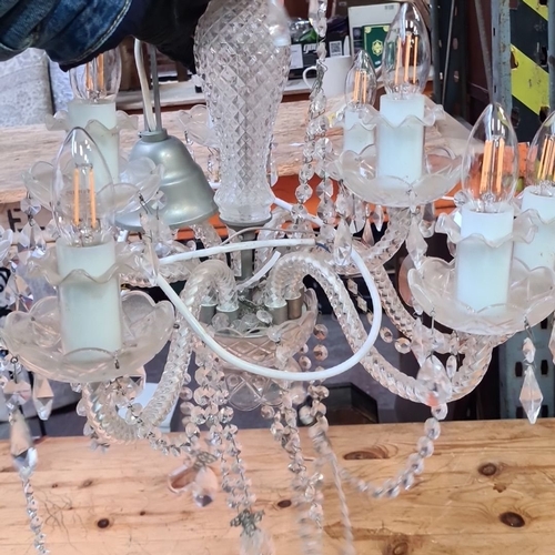 1114 - Star Lot : A large Vintage crystal chandelier with 10 arms and decorative faceted crystal drops, fea... 