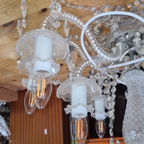 1114 - Star Lot : A large Vintage crystal chandelier with 10 arms and decorative faceted crystal drops, fea... 