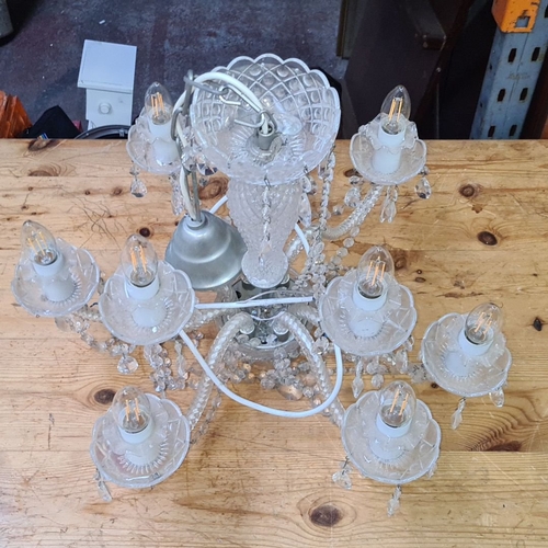 1114 - Star Lot : A large Vintage crystal chandelier with 10 arms and decorative faceted crystal drops, fea... 