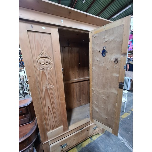 1132 - Victorian, Art Nouveau pine wardrobe with carved details, mirrored door, and lower drawer. With rail... 