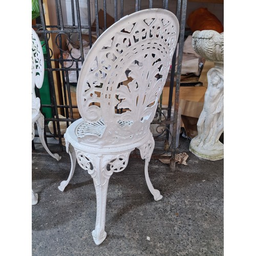 638 - Star Lot : A set of four white metal Garden chairs. Features cabriole legs and pierced floral patter... 