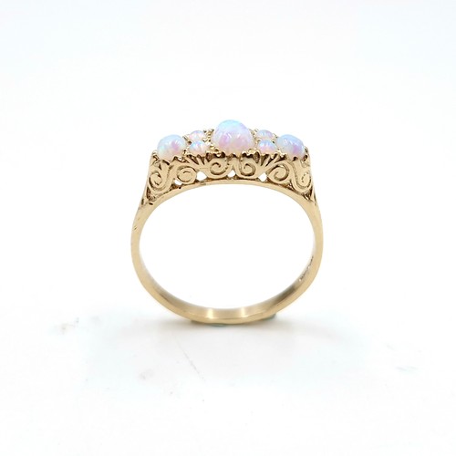 1 - Star lot : A pretty nine carat gold seven stone opal ring. Size - O. Weight - 2.12 grams.