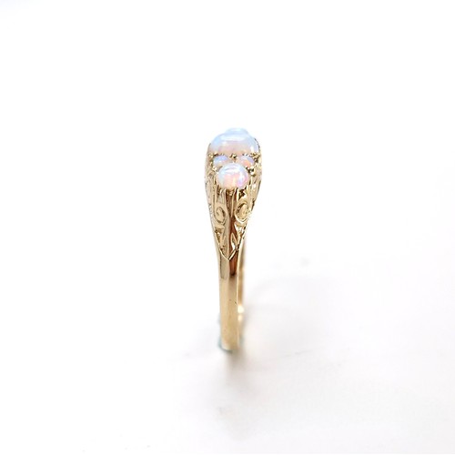 1 - Star lot : A pretty nine carat gold seven stone opal ring. Size - O. Weight - 2.12 grams.