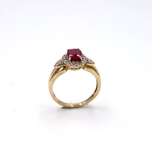 9 - Star lot : A nice example of a ruby stone ring with diamond surround set in nine carat gold. Size - ... 