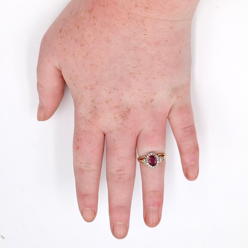 9 - Star lot : A nice example of a ruby stone ring with diamond surround set in nine carat gold. Size - ... 