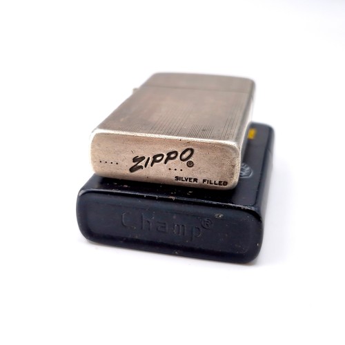 49 - Two flint lighters - one Zippo and one marked 'Crusher'.