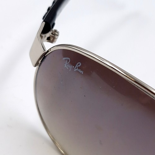 564 - A pair of Ray-Ban aviator sunglasses with raised motifs to frames. Lenses clear with no scratches, w... 