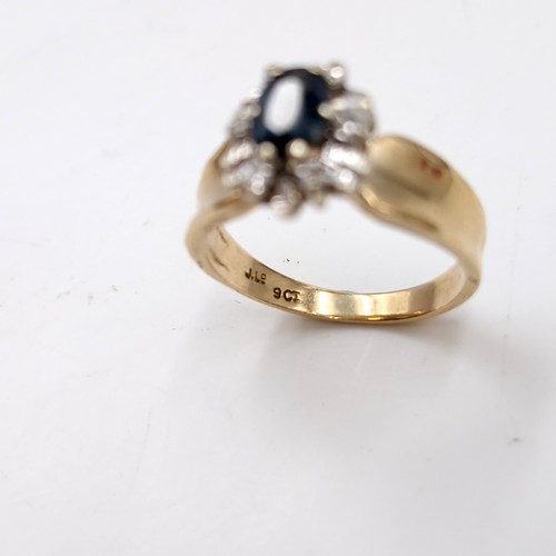 593 - Star lot : A nine carat gold diamond and sapphire stone ring with wide band mount. Size - L. Weight ... 