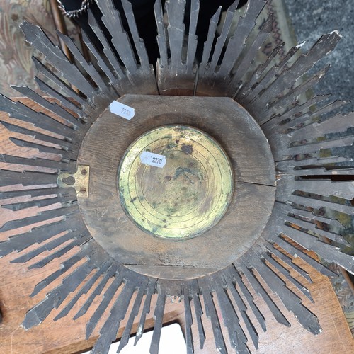 738 - A rather striking antique wooden sunburst clock with protective glass dome to dial.