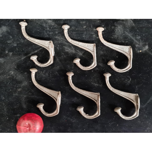 245 - A selection of six cast metal train style wall mounted coat/hat hooks.