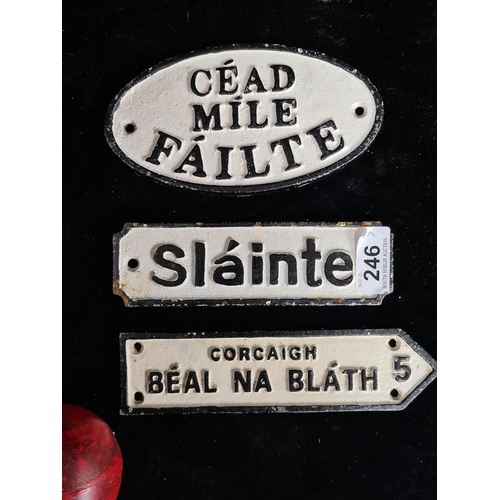 246 - Three cast metal wall signs including one reading 'Slainte' and another reading 'Cead Mile Failte'.