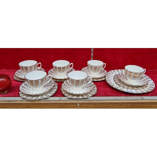 278 - A pretty gilt design Royal Vale bone china tea set. 19 pieces total including 6 cups, saucers, plate... 