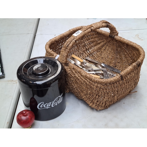 308 - A charming vintage wicker picnic basket containing mixed silverplate cutlery and a CocaCola branded ... 