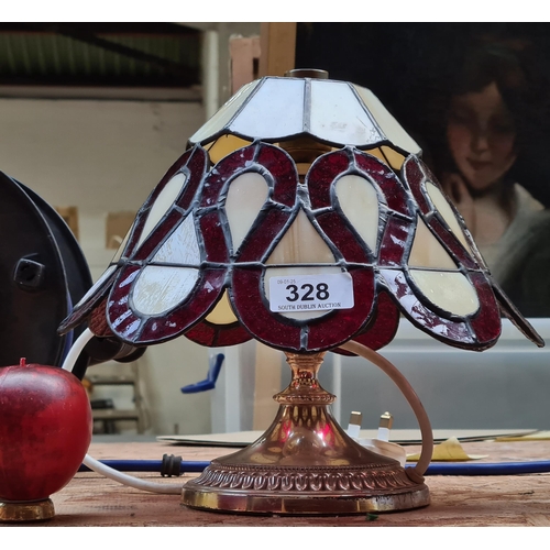 328 - A lovely stained glass Tiffany style table lamp featuring shade with red looping design.