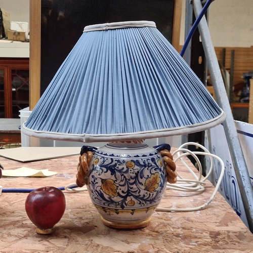 329 - A lovely handpainted ceramic lampshade. Features floral pattern in blue and yellow shades. With a te... 