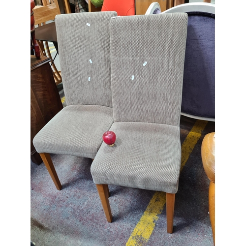 353 - A pair of comfortable dining chairs with solid beechwood legs and suede and hardwearing upholstery.