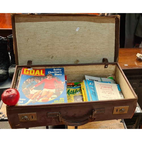 368 - A vintage hard shell leather suitcase containing an array of sporting magazines and publications inc... 