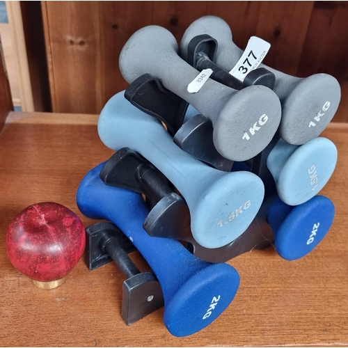 377 - A set of 1kg, 1.5kg and 2kg fitness hand weights with stand.