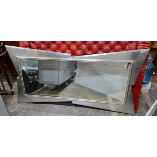 945 - Star Lot : A large and funky wall mounted Silver bevelled mirror. Housed in a lightning bolt style f... 