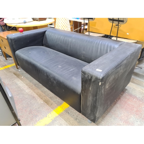 982 - A sleek and stylish black leather three seater sofa with low back and high arm supports.
Previous in... 