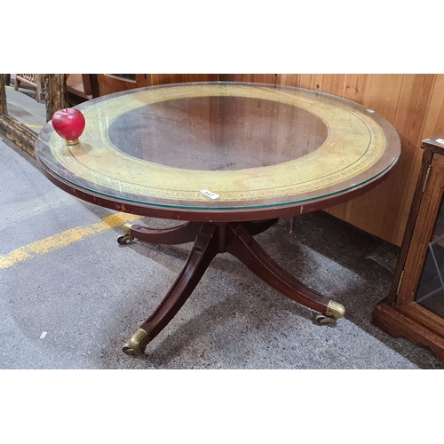 995 - Vintage round glass-top coffee table with brass casters and decorative inlaid tooled leather interio... 