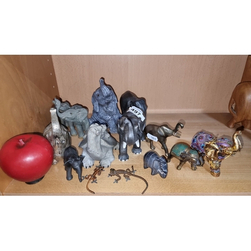 1001 - Elephant figurine collection includes diverse materials such as wood, metal, and resin with vibrant,... 