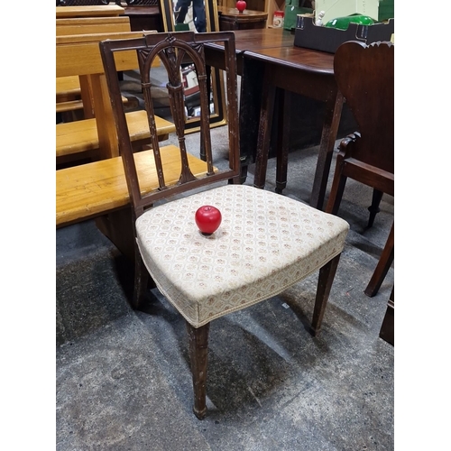 1045 - Early 20th-century wooden chair with elegant Gothic-inspired backrest and patterned upholstery.  fro... 