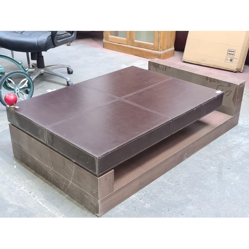 1064 - A rather striking large designer coffee table. Features wooden frame and stylish brown leather table... 