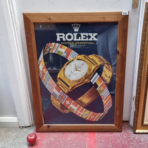 1082 - A large advertising print for Rolex's Oyster-Perpetual watch. Housed in a wooden frame behind plasti... 