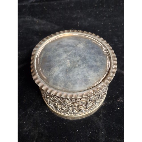 105 - A very pretty possibly Indian silver  lidded box featuring intricate floral and scrollwork design on... 