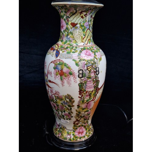 120 - A large Chinese hand painted porcelain table lamp in a Famile Rose style. Mounted on rosewood stand ... 