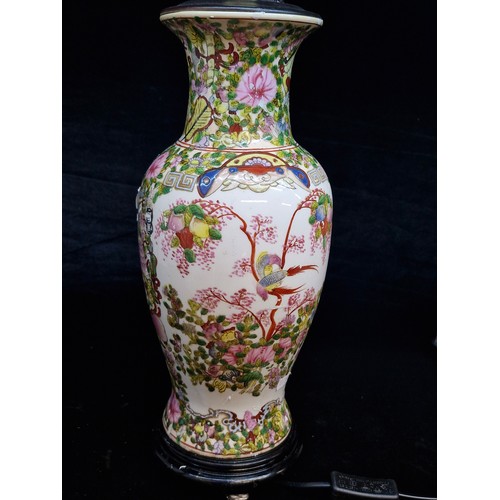 120 - A large Chinese hand painted porcelain table lamp in a Famile Rose style. Mounted on rosewood stand ... 