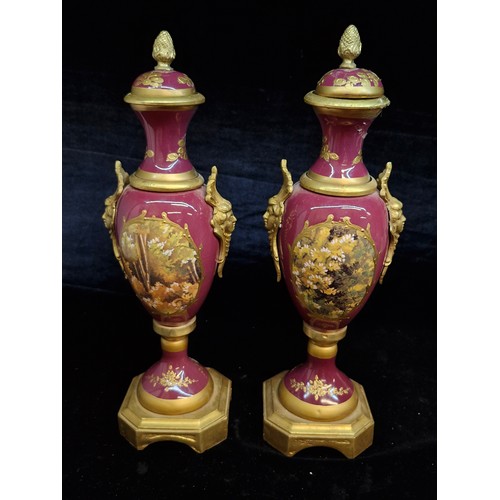 121 - Star Lot : A fabulous large pair of French Sevres style gilt and enameled brass vases.  Featuring ha... 