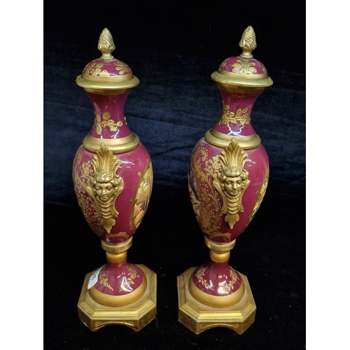 121 - Star Lot : A fabulous large pair of French Sevres style gilt and enameled brass vases.  Featuring ha... 