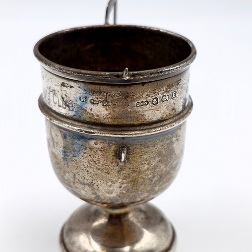 33 - A sterling silver cup hallmarked Birmingham. Height - 7.5 cms. Weight - 34.39 grams (at fault - one ... 