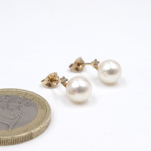 1 - Star lot : A pair of nine carat gold cultured pearl & diamond set stud earrings. Total weight - 1.67... 