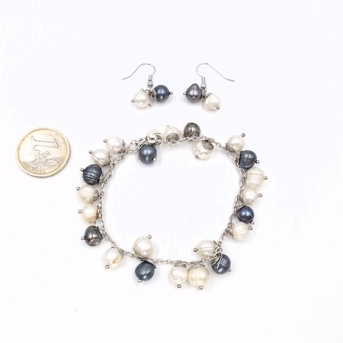 23 - A sterling silver pearl bracelet together with a matching pair of earrings - suitable for pierced ea... 