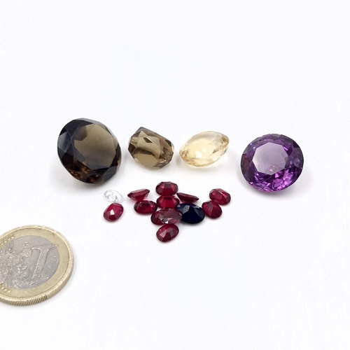 36 - An assorted collection of fabulous gemstones consisting of s stunning amethyst, smokey quartz, citri... 